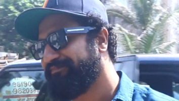 Vicky Kaushal poses with fans in a blue shirt & scruffy beard