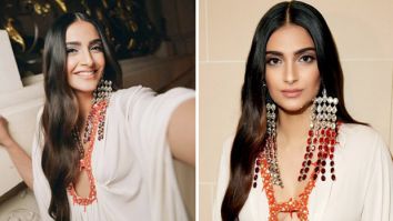 Sonam Kapoor radiates elegance in a flowy white dress, adorned with ombre and ruby-red dangler earrings