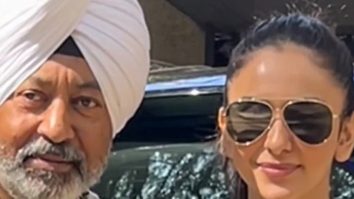 Rakul Preet Singh poses for a picture with a fan as she gets clicked