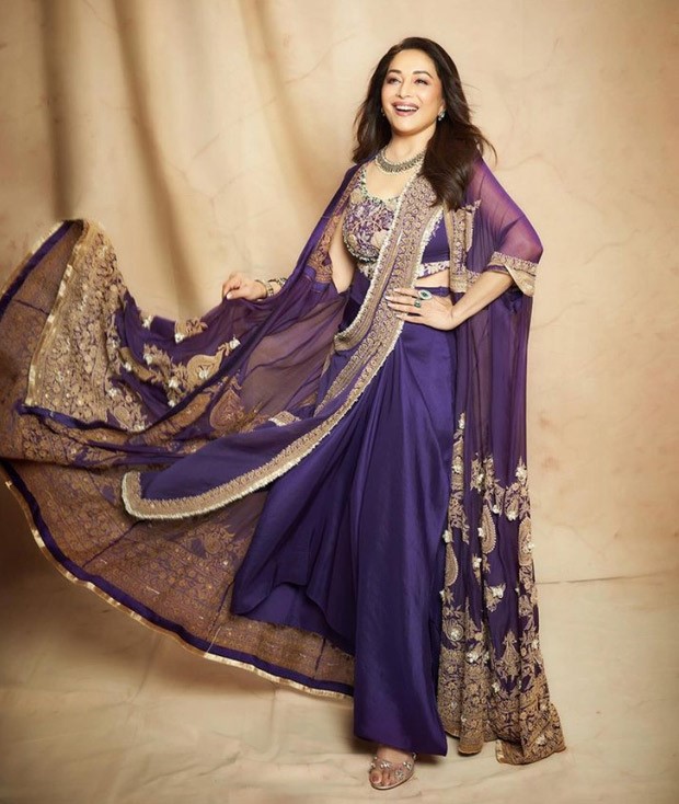 Madhuri Dixit made a chic case for a purple statement pre-draped saree by Anamika Khanna perfect for the festive season