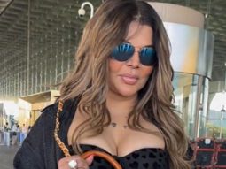 Rakhi Sawant carries a unique purse with her mom’s portrait, shows it to paps at the airport
