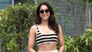 Sharvari Wagh smiles as she poses in her black and white striped outfit