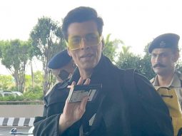 Karan Johar poses with Karisma Kapoor at the airport