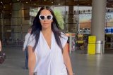 Neha Dhupia poses for a selfie with fans at the airport