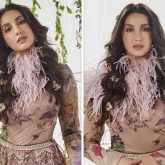 Nora Fatehi dazzles in classic metallic silk lehenga by Varun Bahl paired with bodysuit and pink feather collar