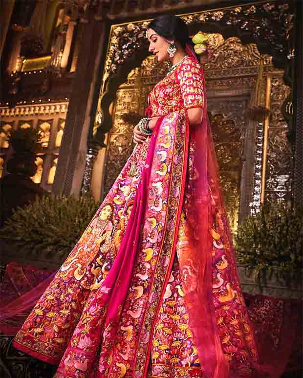 Anant Ambani–Radhika Merchant Wedding Newlywed bride exudes opulence in custom Abu Jani Sandeep Khosla red lehenga featuring 12 hand-painted panels