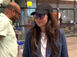 Karisma Kapoor poses for a picture with fans at the airport