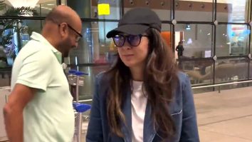 Karisma Kapoor poses for a picture with fans at the airport