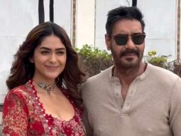 Mrunal Thakur with a glamour red fit pose with co star Ajay Devgn
